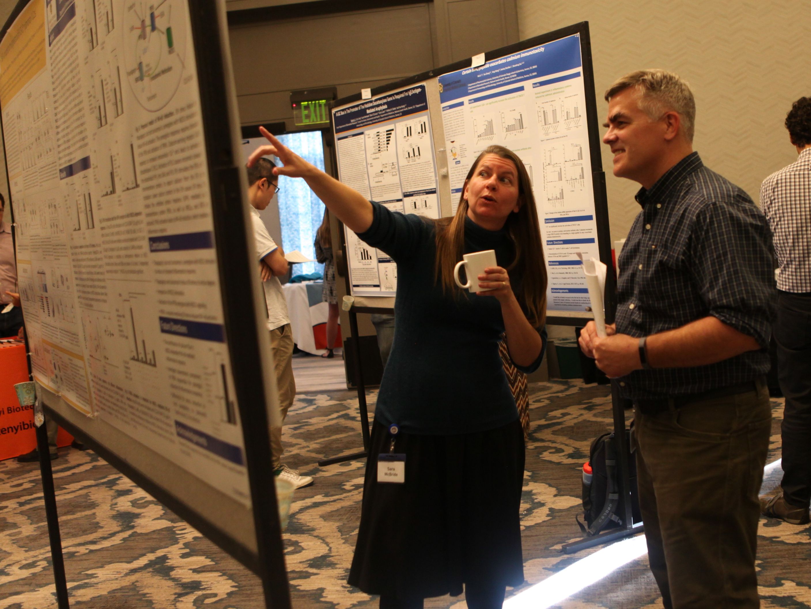 Sara McBride presenting a abstract poster to Marty Voskuil in 2018