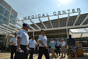 VA medical center with people walking in front of it