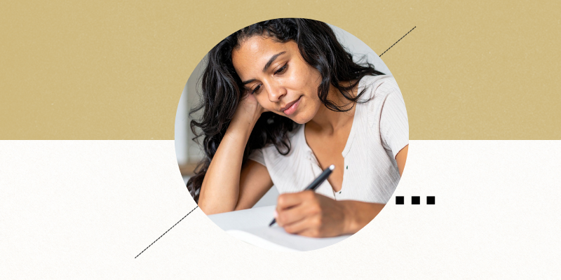 Hispanic woman writing in a book