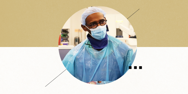 John Berry-Candelario, MD, in surgical cap and mask in a skills lab
