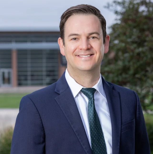 male doctor in a blue suit outside
