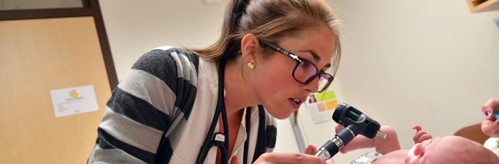 doctor examining baby during visit