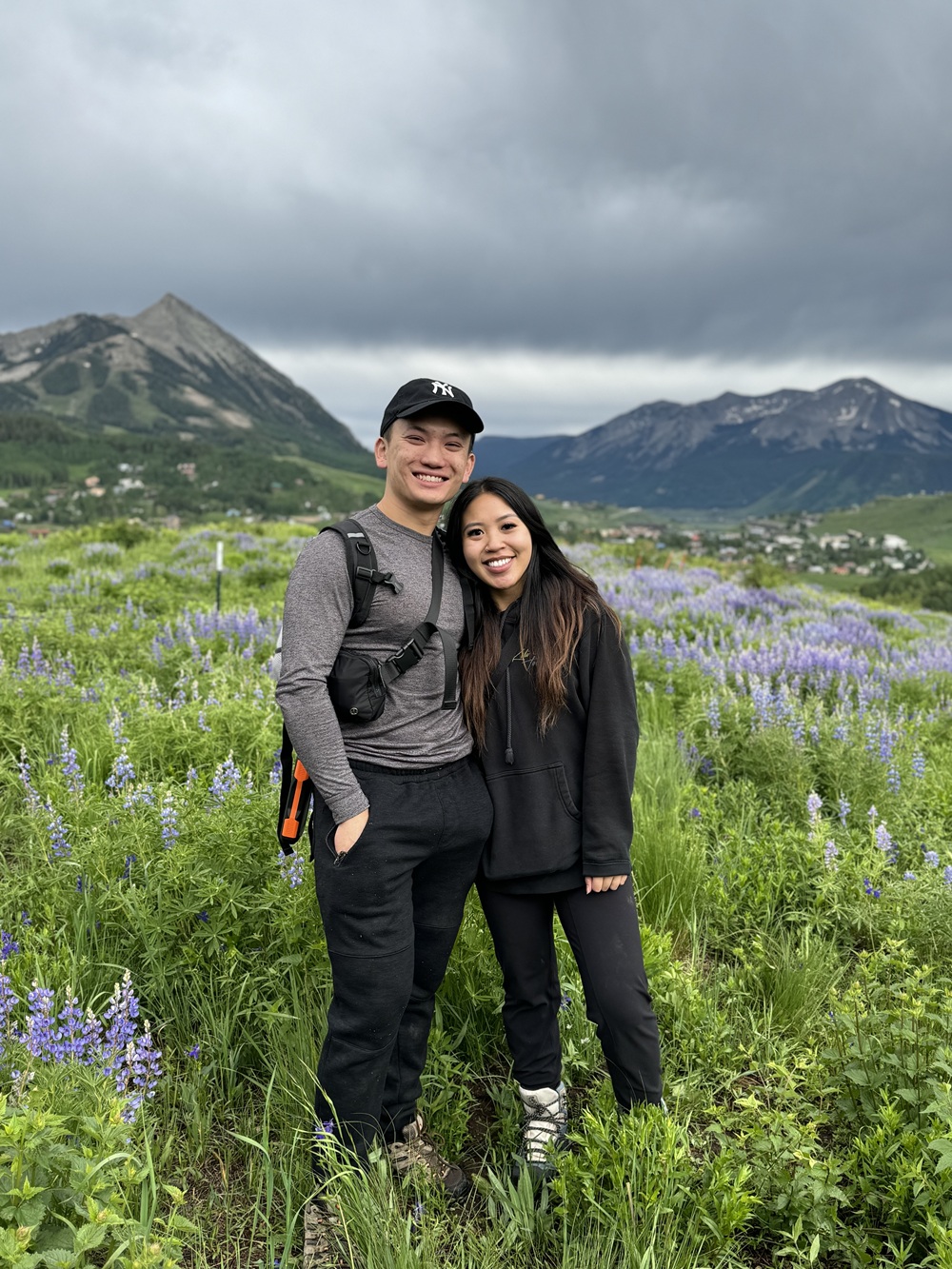 Dr. Le standing next to a woman in an alpine valley.