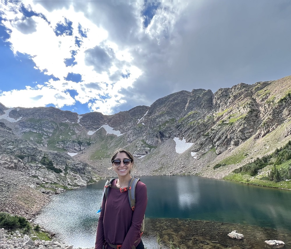 Photo of Dr. Nikolis next to a mountain lake.