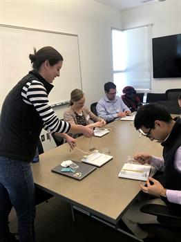 Stephanie Davis teaching knot-tying to MSIII's