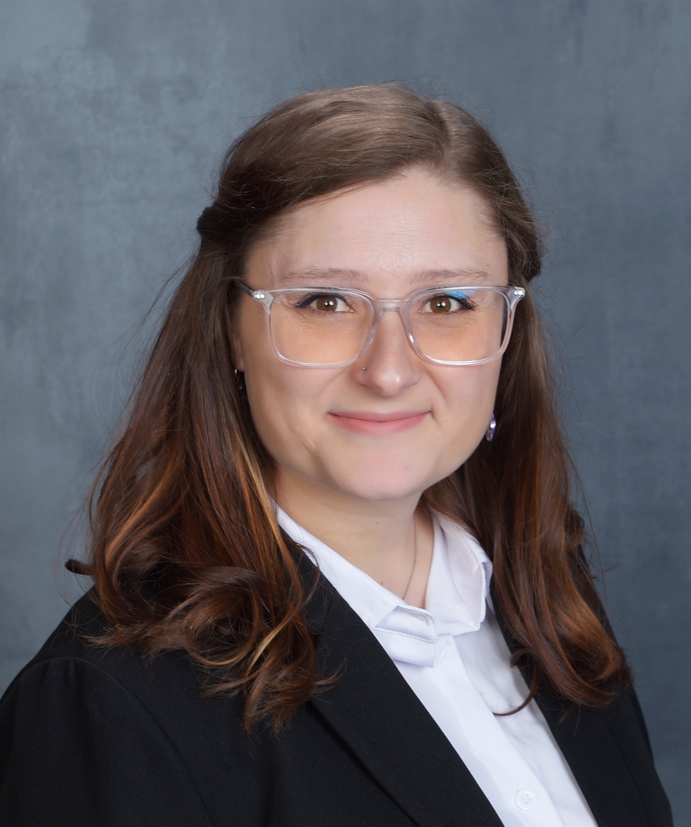 Professional headshot of woman in blazer.