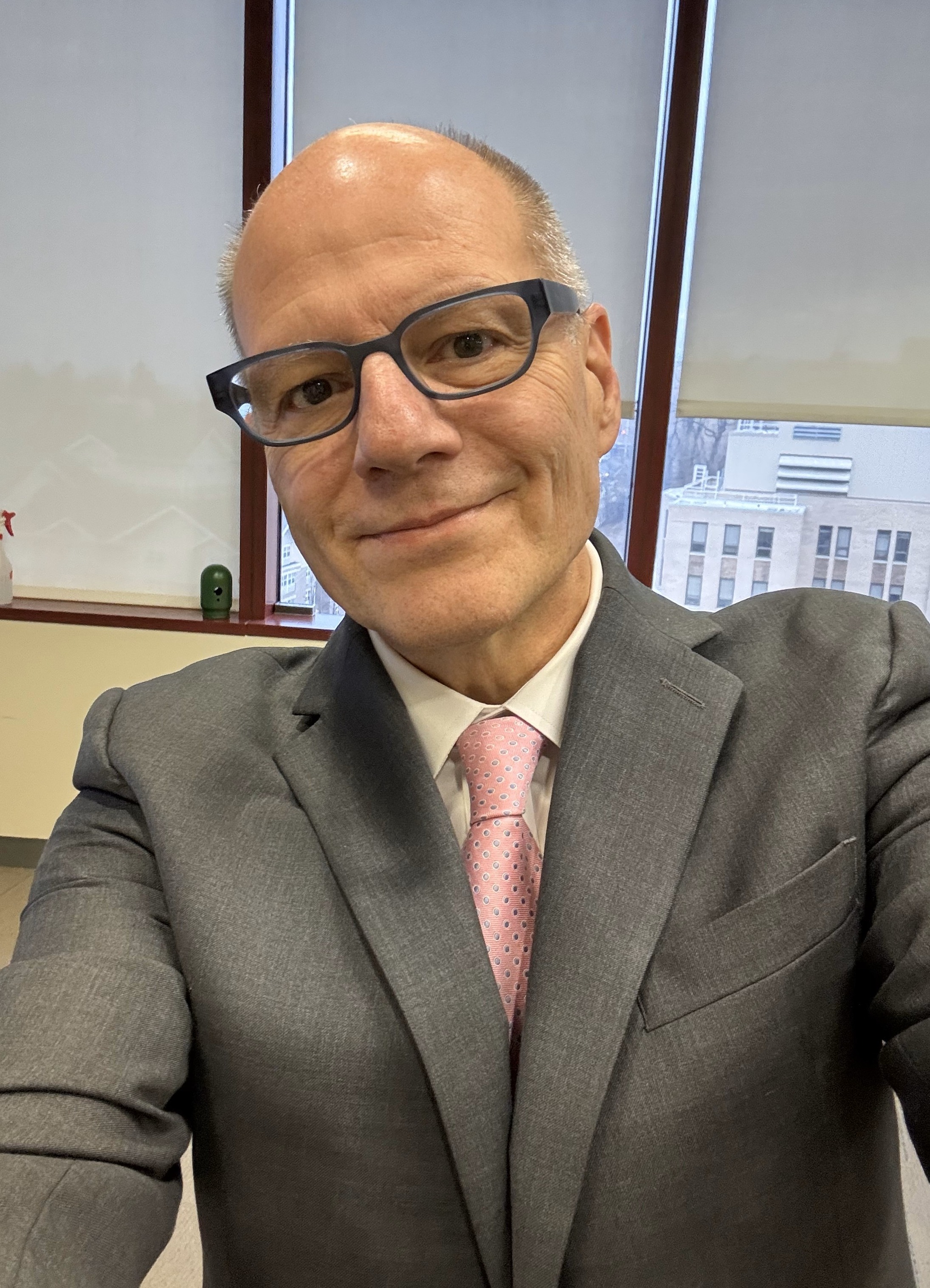 Selfie of man in suite with pink tie