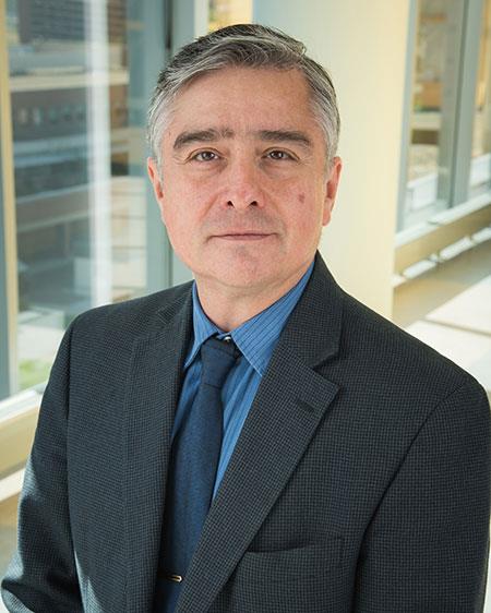 Professional headshot of man in suit