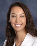 Headshot photograph of women in a lab coat.