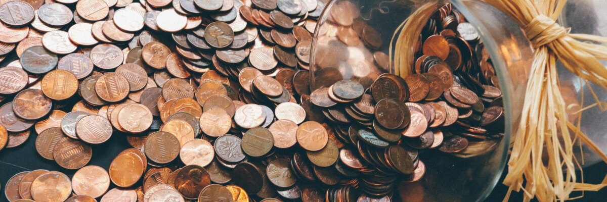 Pennies dumped out of a glass jar