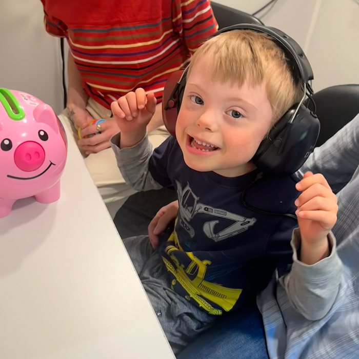 Young boy with Down syndrome wearing headphones