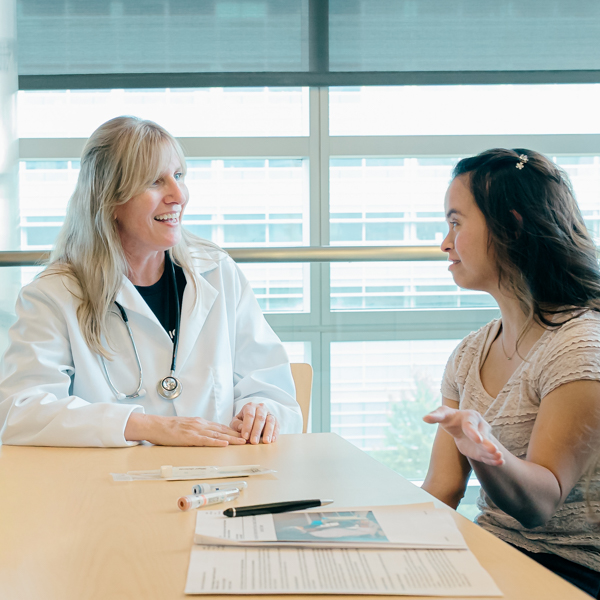 Doctor talking to a woman with Down syndrome