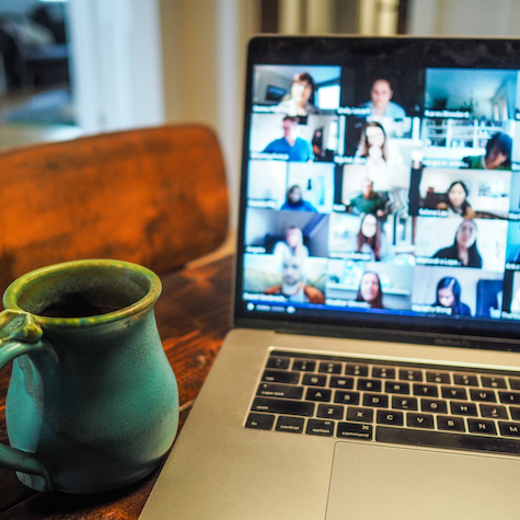 Coffee mug next to computer in zoom meeting