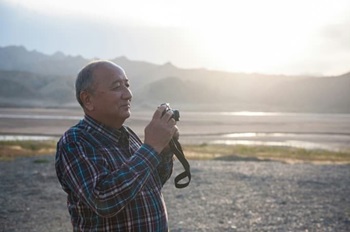 Older man taking photos outdoors