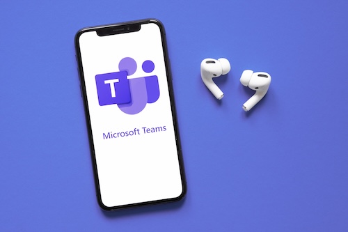 Image of a cell phone with Teams Calling logo and ear buds next to it.